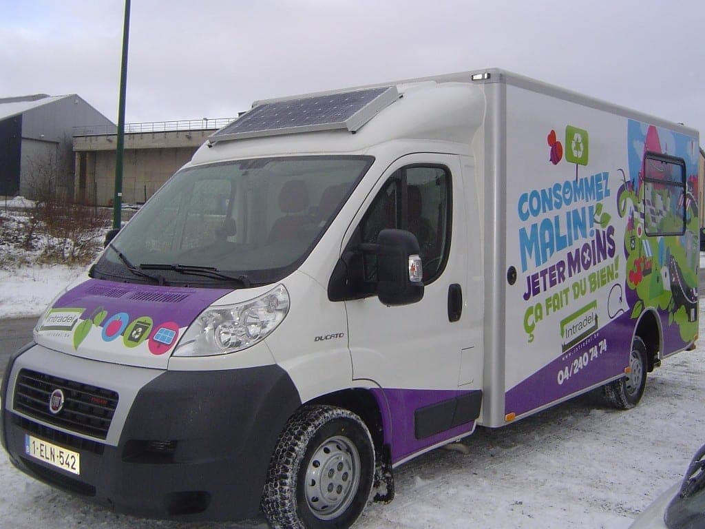 Fiat Ducato à caisse aménagée aux couleurs d’une campagne de prévention des déchets, panneaux solaires en toiture